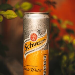 orange and black can on brown wooden table