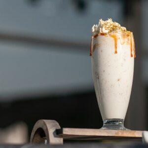 a glass of milk with a spoon