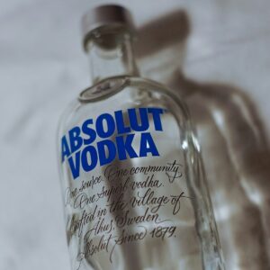 clear glass bottle on white textile