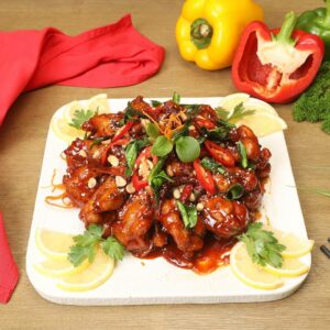 a white plate topped with meat covered in sauce
