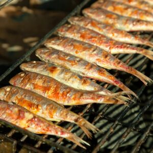 a bunch of fish that are on a grill