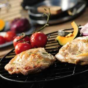 a close up of two meats on a grill