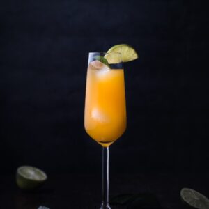 orange juice on clear glass