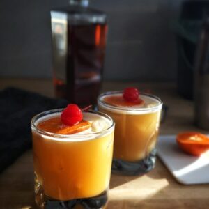 a couple of glasses filled with drinks on top of a table