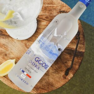 a bottle of vodka sitting on top of a wooden table